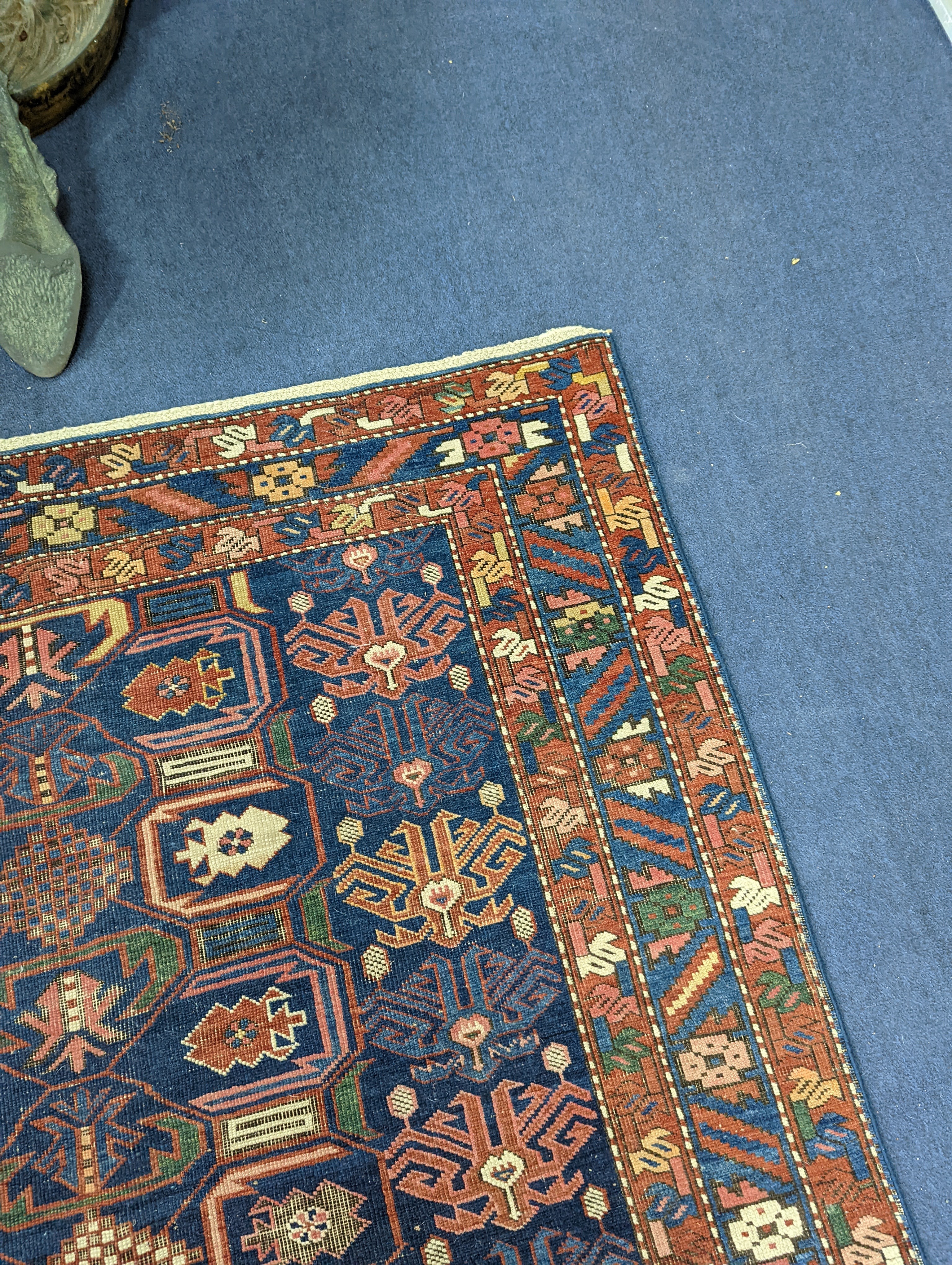 An antique Caucasian blue ground rug, 260 x 130cm